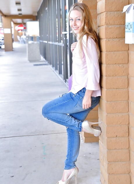 Slender blond teen Bre Blu in sexy jeans exhibiting small tits and spreading her legs outside